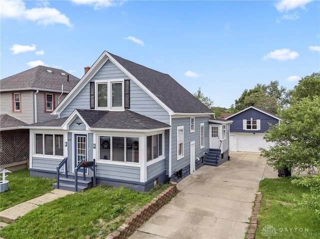 4119 Pleasant View Ave, Dayton, OH 45420 - view of front of property with roof with shingles, entry steps, an outdoor structure, and a detached garage