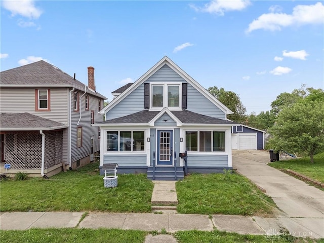 4119 Pleasant View Ave, Dayton, OH 45420 - bungalow-style home with a front lawn, roof with shingles, a detached garage, and an outbuilding