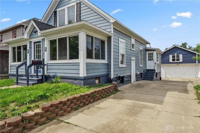 4119 Pleasant View Ave, Dayton, OH 45420 - view of front facade featuring entry steps, an outbuilding, and a garage