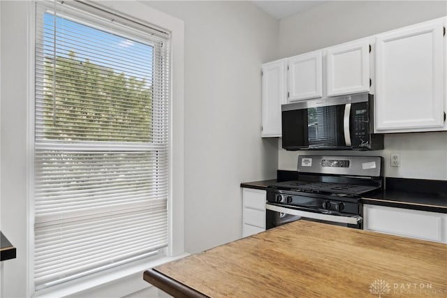4119 Pleasant View Ave, Dayton, OH 45420 - kitchen featuring stainless steel appliances, white cabinetry, and dark countertops