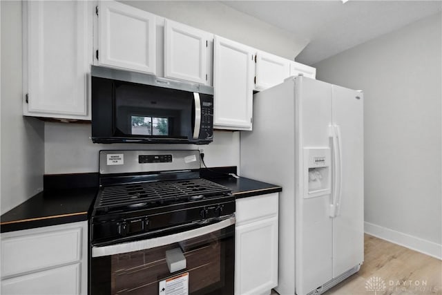 4119 Pleasant View Ave, Dayton, OH 45420 - kitchen featuring stainless steel appliances, dark countertops, white cabinetry, and light wood-style floors