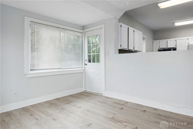 4119 Pleasant View Ave, Dayton, OH 45420 - unfurnished dining area with baseboards and light wood-style flooring