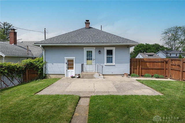 2526 Saint Charles Ave, Dayton, OH 45410 - rear view of house featuring a fenced backyard, a patio area, a shingled roof, and a chimney