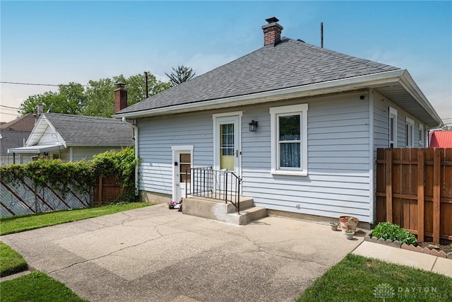 2526 Saint Charles Ave, Dayton, OH 45410 - rear view of property featuring a patio, a chimney, and roof with shingles