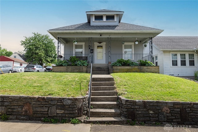 2526 Saint Charles Ave, Dayton, OH 45410 - bungalow-style home featuring a front lawn, covered porch, and roof with shingles