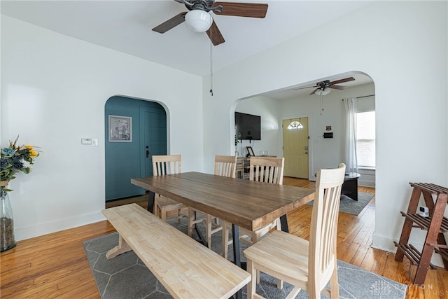 2526 Saint Charles Ave, Dayton, OH 45410 - dining area with arched walkways, a ceiling fan, and light wood-style flooring