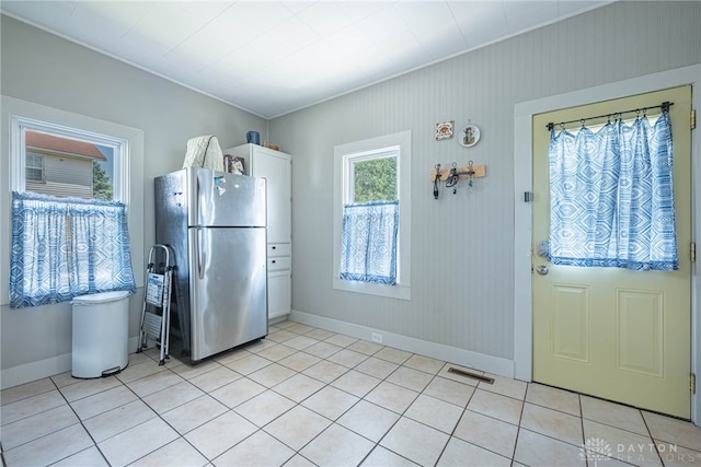 2526 Saint Charles Ave, Dayton, OH 45410 - kitchen with freestanding refrigerator, light tile patterned flooring, white cabinetry, and crown molding