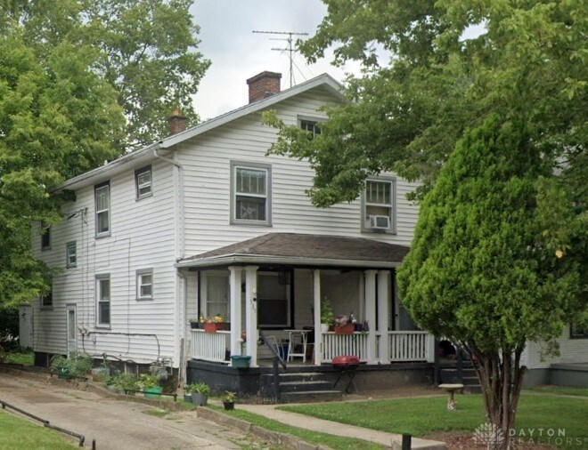 537 Cedarhurst Ave Unit 535, Dayton, OH 45402 - view of front of home featuring covered porch, a chimney, a front yard, and cooling unit