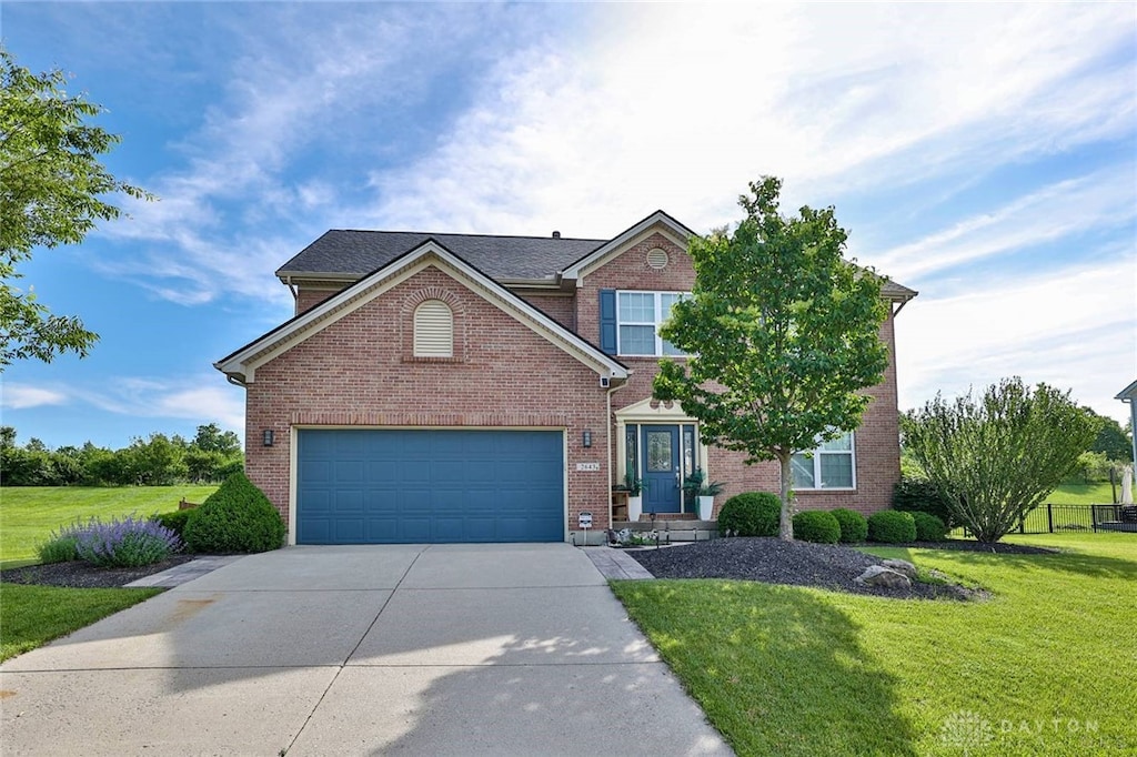 2643 Riverchase Dr, Middletown, OH 45042 - traditional home with concrete driveway, a front yard, brick siding, and a garage