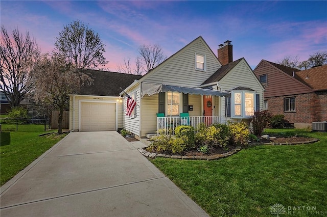 1236 Ridgeview Ave, Kettering, OH 45409 - view of front of house featuring covered porch, driveway, a garage, a chimney, and roof with shingles