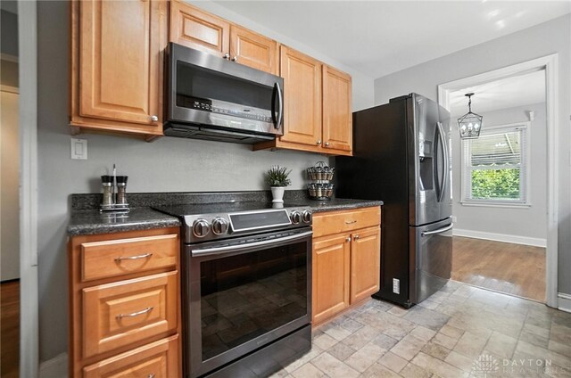 1236 Ridgeview Ave, Kettering, OH 45409 - kitchen featuring appliances with stainless steel finishes, a chandelier, and light stone finish floors