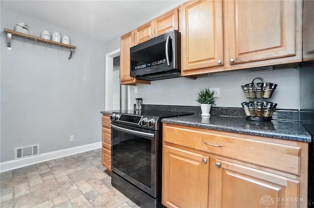 1236 Ridgeview Ave, Kettering, OH 45409 - kitchen featuring stainless steel microwave, range with electric stovetop, stone finish floors, light brown cabinetry, and dark stone counters