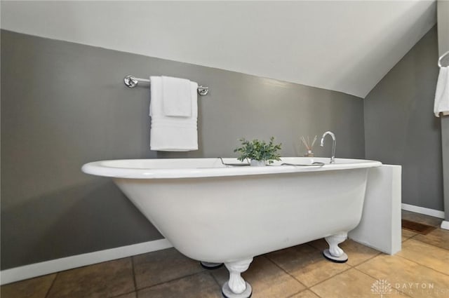 1236 Ridgeview Ave, Kettering, OH 45409 - bathroom with vaulted ceiling, a freestanding bath, and tile patterned flooring