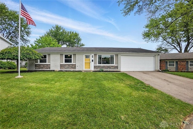 ranch-style home with a garage, driveway, a front yard, and stone siding
