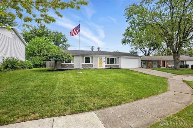 ranch-style home with a garage, concrete driveway, a front lawn, and stone siding