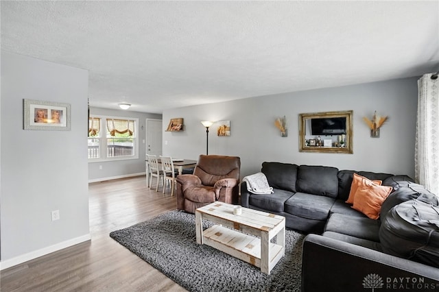 living area featuring wood finished floors and baseboards