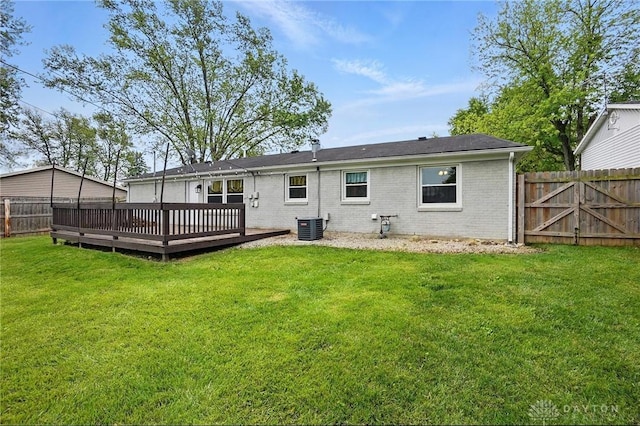 rear view of house with a wooden deck, cooling unit, and brick siding