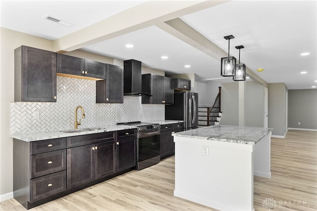 1439 Folk Ream Rd, New Carlisle, OH 45344 - kitchen featuring stainless steel appliances, wall chimney exhaust hood, a sink, a center island, and backsplash