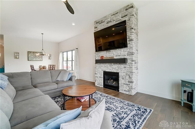 1264 Normandy, Clearcreek Twp, OH 45458 - living room with wood finished floors, baseboards, a stone fireplace, and ceiling fan