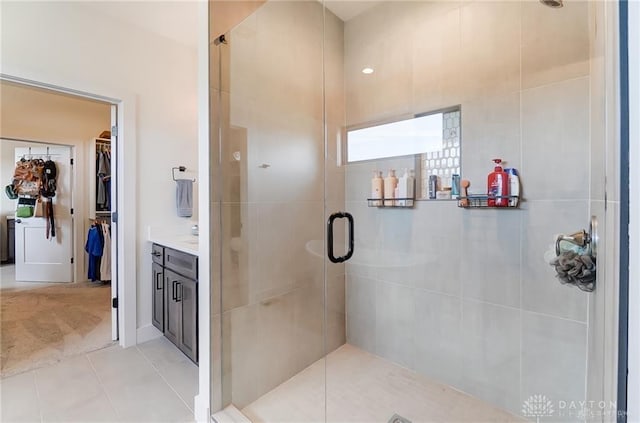 1264 Normandy, Clearcreek Twp, OH 45458 - bathroom featuring a stall shower, a walk in closet, tile patterned flooring, and vanity
