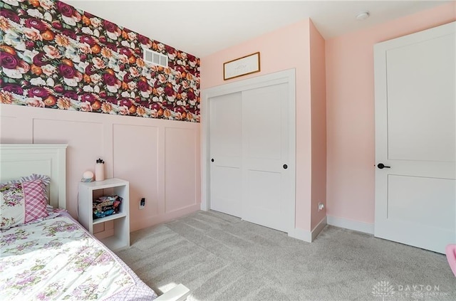 1264 Normandy, Clearcreek Twp, OH 45458 - bedroom featuring light carpet, a closet, a decorative wall, wainscoting, and wallpapered walls