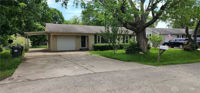 ranch-style home featuring concrete driveway, a front lawn, a carport, and an attached garage