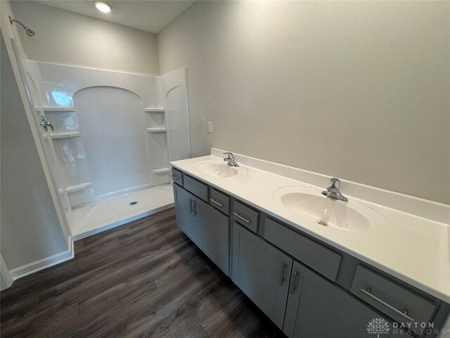 546 Hollywood Blvd, Xenia, OH 45385 - full bathroom with a shower, wood finished floors, and double vanity