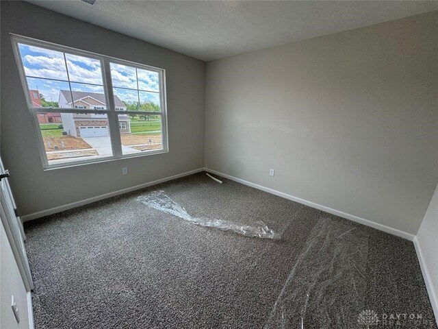546 Hollywood Blvd, Xenia, OH 45385 - spare room featuring carpet floors, baseboards, and a textured ceiling