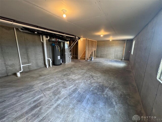 546 Hollywood Blvd, Xenia, OH 45385 - unfinished basement featuring stairs, water heater, and heating unit