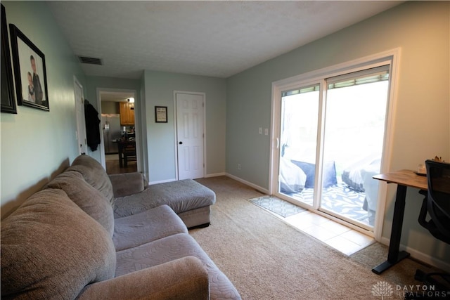 carpeted living room featuring baseboards