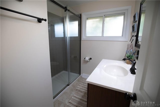 bathroom with a stall shower and vanity