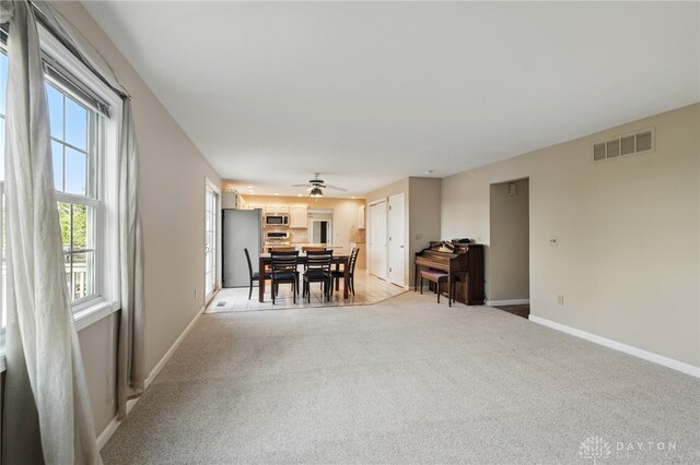 2337 Eastwind Dr, Beavercreek, OH 45434 - dining area featuring light carpet, baseboards, and a ceiling fan