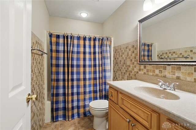2337 Eastwind Dr, Beavercreek, OH 45434 - full bath featuring tile walls, toilet, vanity, shower / bath combo with shower curtain, and tile patterned flooring