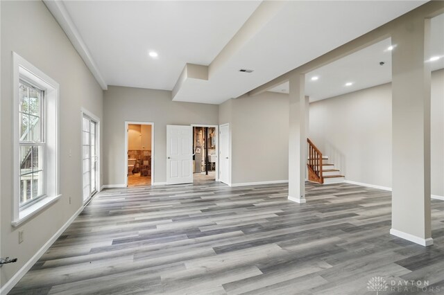 2337 Eastwind Dr, Beavercreek, OH 45434 - unfurnished living room with wood finished floors, stairway, baseboards, and recessed lighting