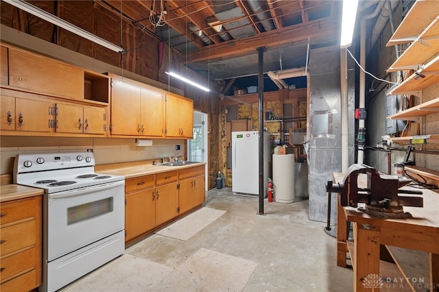 kitchen with white appliances, unfinished concrete flooring, light countertops, and a sink