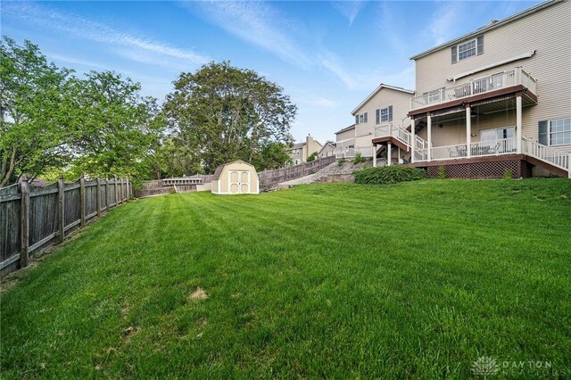 view of yard with a wooden deck and stairway