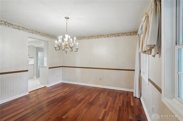 2337 Eastwind Dr, Beavercreek, OH 45434 - empty room with wood finished floors and a chandelier