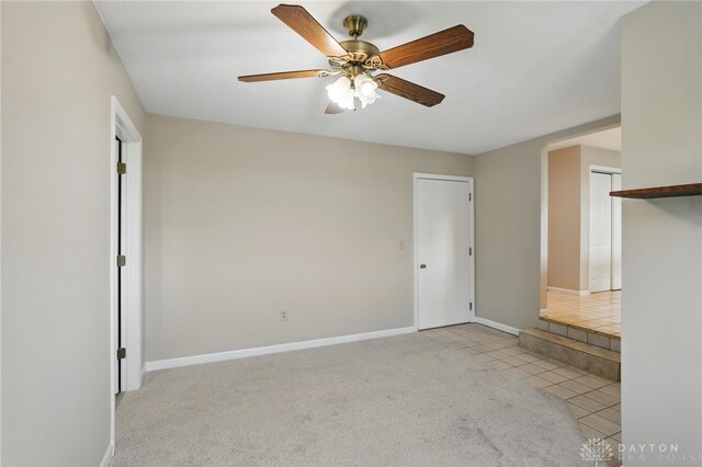 2337 Eastwind Dr, Beavercreek, OH 45434 - unfurnished living room featuring ceiling fan, tile patterned flooring, baseboards, and carpet floors