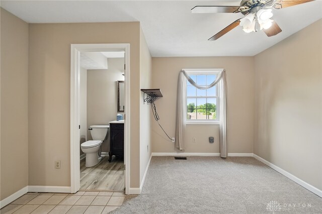 2337 Eastwind Dr, Beavercreek, OH 45434 - unfurnished bedroom featuring baseboards, light colored carpet, connected bathroom, and an office area