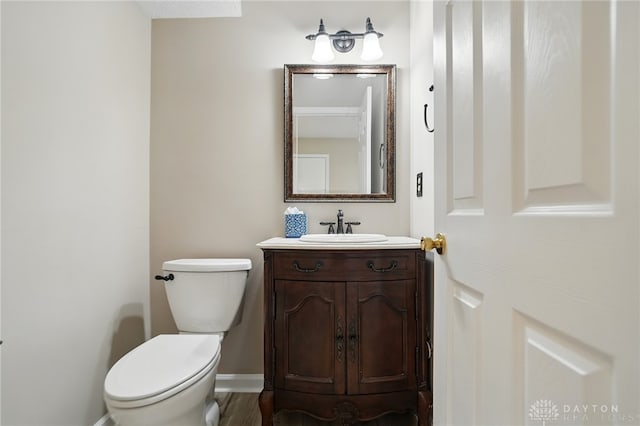 half bathroom with vanity and toilet