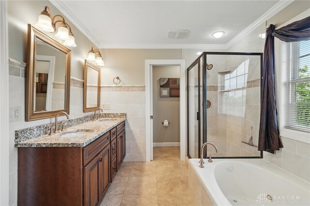 bathroom with tile walls, a stall shower, a bath, double vanity, and ornamental molding