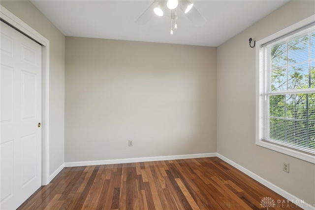 2337 Eastwind Dr, Beavercreek, OH 45434 - unfurnished bedroom with wood finished floors, baseboards, a ceiling fan, and a closet