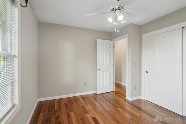 2337 Eastwind Dr, Beavercreek, OH 45434 - unfurnished bedroom with wood finished floors, baseboards, and ceiling fan