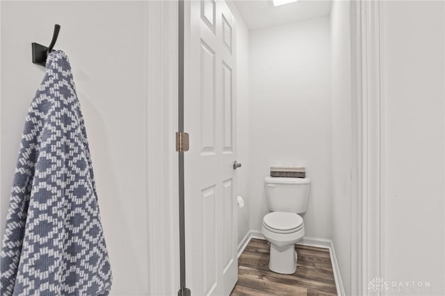 bathroom featuring wood finished floors, toilet, and baseboards