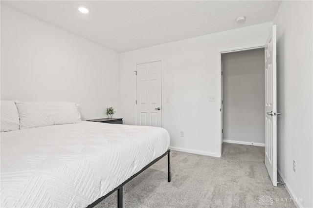 carpeted bedroom with baseboards and recessed lighting