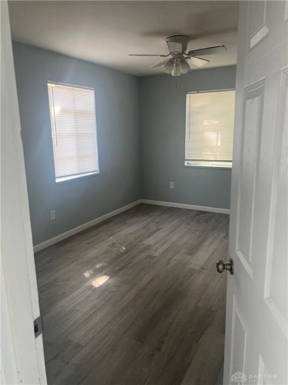 1155 Linda Vista Ave, Dayton, OH 45405 - spare room featuring a ceiling fan, dark wood-type flooring, and baseboards