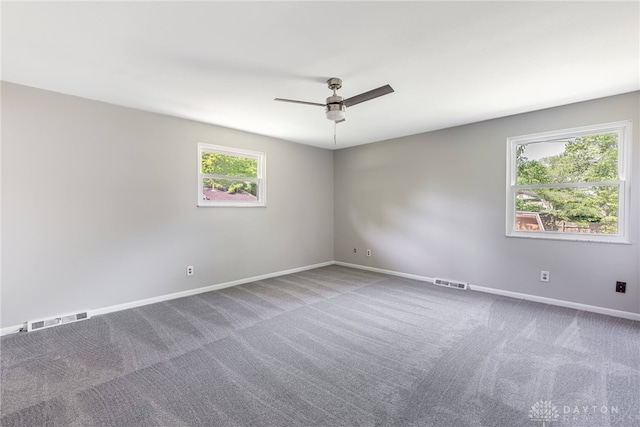 spare room featuring a ceiling fan, carpet flooring, and baseboards