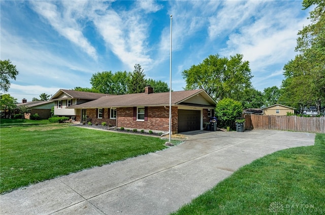tri-level home featuring a chimney, a garage, concrete driveway, and brick siding