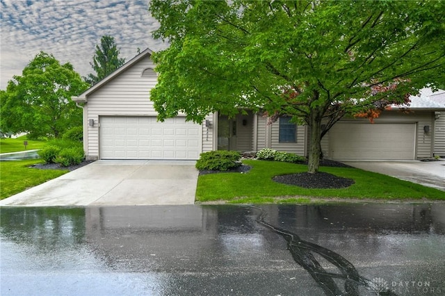 4826 Beechwood Ln, Middletown, OH 45042 - view of property hidden behind natural elements featuring a front lawn, driveway, and a garage