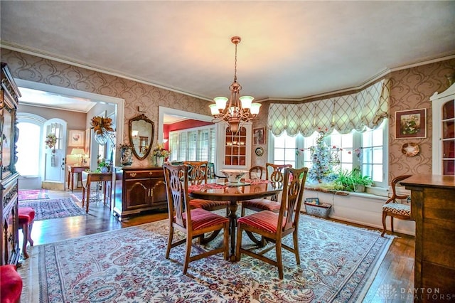 401 Hadley Ave, Dayton, OH 45419 - dining space with wallpapered walls, a chandelier, crown molding, wood-type flooring, and healthy amount of natural light